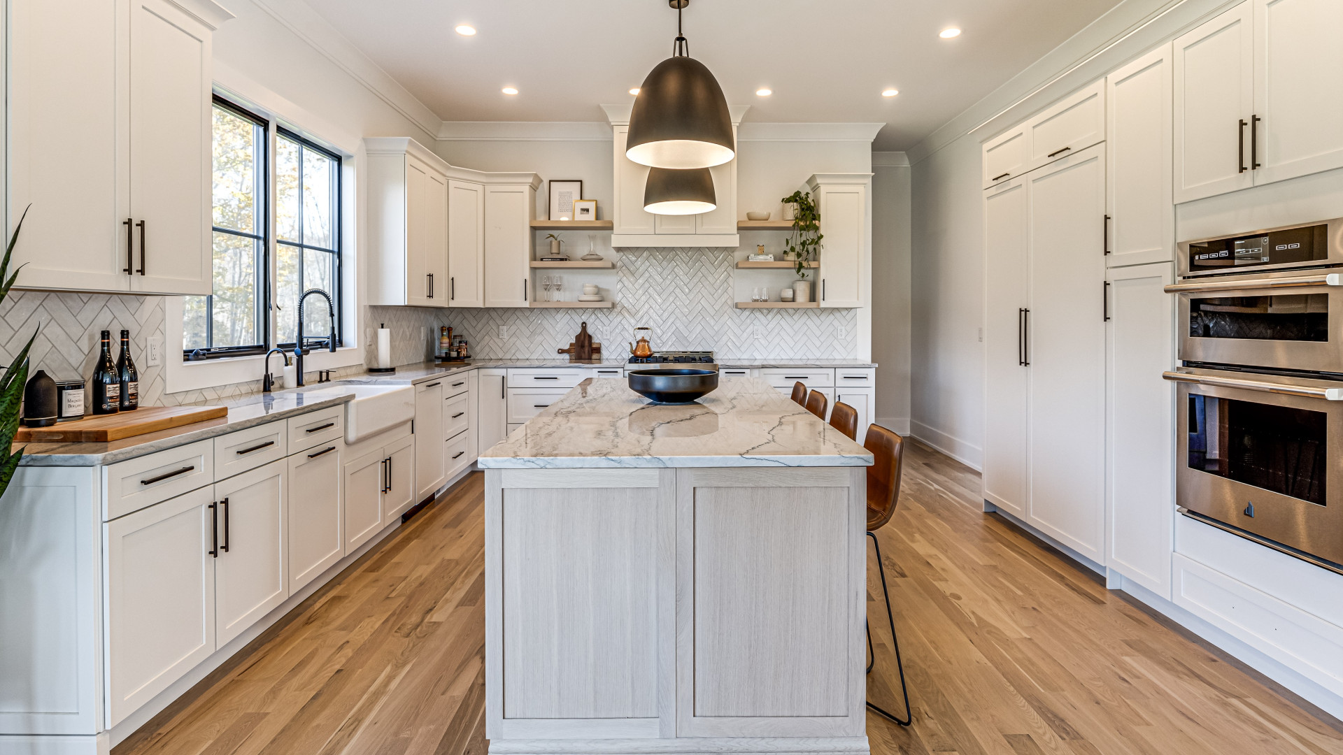 Luxury kitchen featuring custom wooden floors and a herringbone patterned backsplash, New Jersey